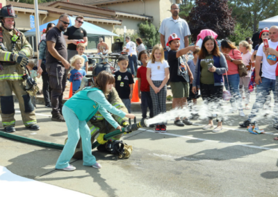 fire station 63 open house girl releasing water from hose WCCFSC 20250118