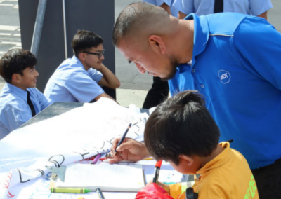 fire station 63 open house man and boy writing on poster WCCFSC 20250118