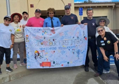 fire station 63 open house volunteers in front of cloth sign WCCFSC 20250118